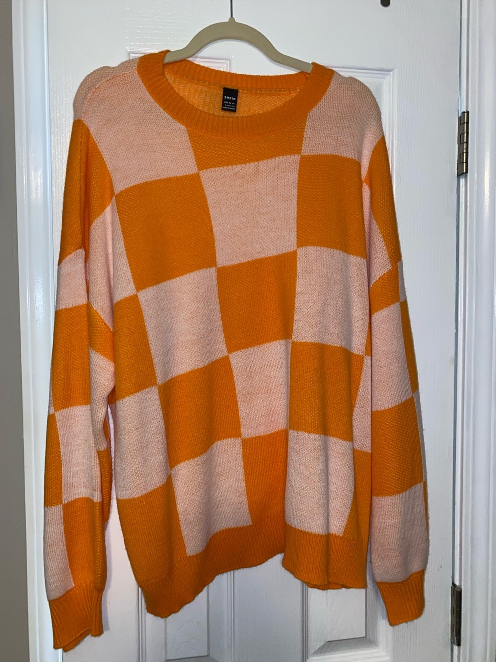 Orange and white checkerboard sweater